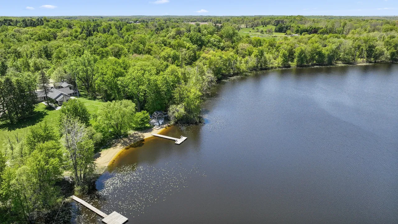 Aerial view of Lake Madron with the property, beach, and dock visible below